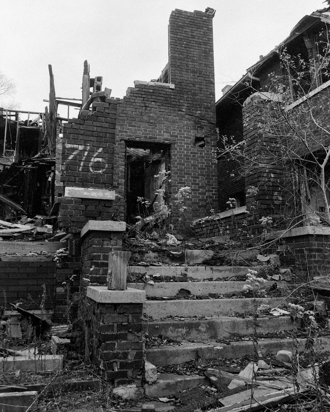 A black-and-white photo of a dilapidated building.